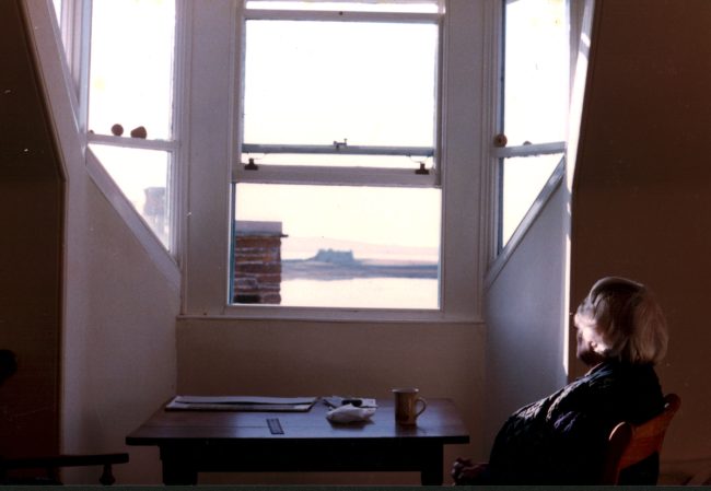 Barns-Graham seated looking out of a window at the Pier Arts Centre, c.1984 © Wilhelmina Barns-Graham Trust
