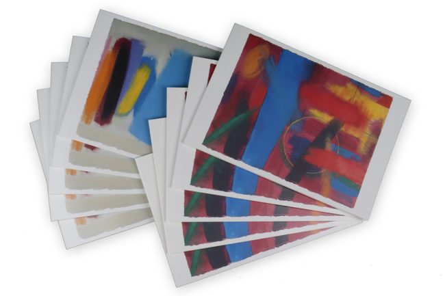 An image of two fans of cards featuring two different abstract paintings, one grey, one red